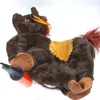 A brown plush horse toy with an orange saddle and an orange pump next to it, lying on a white background. Produktbild-Vorschau
