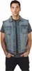 A man wearing a denim vest over a gray t-shirt and black pants, posing with his hands in his pockets. Produktbild-Vorschau