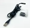 A black USB cable with a magnetic charging connector and two small adapters in a plastic bag, laid out on a white background. Produktbild-Vorschau