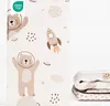 A folded fabric product with a space-themed pattern, featuring bears in astronaut suits and rockets. Produktbild-Vorschau