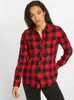 A woman wearing a red and black checkered flannel shirt. Náhled obrázku produktu