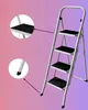 A gray metal step ladder with four black steps is shown against a gradient background of pink and purple. Náhled obrázku produktu