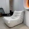 A modern living room with a unique beige sofa. Anteprima dell’immagine prodotto