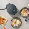 A dark gray waffle maker with waffles and berries on a light gray surface. Anteprima dell’immagine prodotto