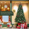 A Christmas tree decorated with ornaments and bows, displayed in a store window with gift boxes below. Produktbild-Vorschau