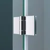 A close-up view of a shower door hinge connecting two glass panels. Produktbild-Vorschau