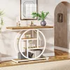 A console table with shelves is placed in an entryway, decorated with books, a vintage radio, and a vase with greenery. A mirror hangs above it, and an arched doorway is visible to the right. Anteprima dell’immagine prodotto