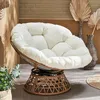 A papasan chair with a white cushion is shown in a room with brick walls and decorative vases. Produktbild-Vorschau