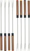 A set of fondue forks displayed against a white background. The set includes four forks with clear plastic prongs and white handles, and four forks with copper-colored handles and silver prongs. Podgląd zdjęcia produktu