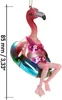 A glass Christmas ornament of a flamingo wearing a bikini and sitting on a swim ring. Produktbild-Vorschau