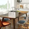 A felt shopping basket sits on a wooden dining table in a bright, modern kitchen. Produktbild-Vorschau