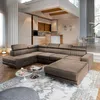 A spacious, modern living room with a large sectional sofa, kitchen area, and dining area. Produktbild-Vorschau