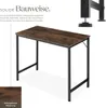 A desk with a dark wood top and black metal legs, shown from a slightly elevated angle. Text describes its solid construction and adjustable feet. A close-up of the wood grain is also shown. Náhled obrázku produktu