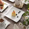 A table setting with plates of food and drinks. Náhled obrázku produktu