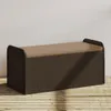 A brown poly rattan storage bench with a tan cushion sits on a wooden deck against a light gray wall. Náhľad obrázku produktu
