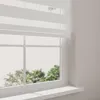 A close-up view of a white window with blinds and a windowsill. Produktbild-Vorschau