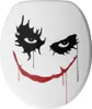 A white toilet seat with a Joker-like face design. Náhled obrázku produktu
