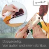 Hands applying a window sticker of a reindeer to a window. Produktbild-Vorschau