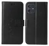 A black flip phone case with a floral and butterfly embossed design on the left side, and the back of the case with a camera cutout on the right side. Produktbild-Vorschau