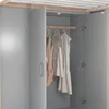 Interior view of a gray wardrobe with clothes hanging on a rod. Voir les images du produit