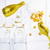 A New Year's Eve party setup with balloons, a cake, and table settings. Produktbild-Vorschau