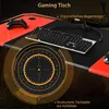 A close-up view of a gaming desk with a keyboard, controller, and a circular graphic overlay. Produktbild-Vorschau