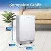 A white air purifier is shown next to a potted plant and a couch in a room. Produktbild-Vorschau