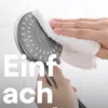 A hand is cleaning a shower head with a white cloth. Produktbild-Vorschau