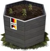 A hexagonal raised garden bed filled with soil and young plants, sitting on artificial grass. Produktbild-Vorschau