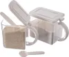 Two clear plastic storage containers with white lids and handles, filled with powdered ingredients, are shown against a white background. One container's lid is open, revealing a scoop inside. A separate scoop is also visible in the foreground. Anteprima dell’immagine prodotto