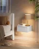 A bedside scene with a floating nightstand, a lamp, and a bed. Náhled obrázku produktu