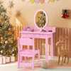 A pink children's vanity set with a chair is set up in a festive room decorated for Christmas, with a decorated Christmas tree and festive decorations on the wall. Náhľad obrázku produktu
