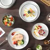 A beautifully set table with various dishes and tableware, suggesting a meal or dining experience. Náhled obrázku produktu