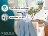A light blue blanket draped over a sofa in a living room setting, with decorative elements like plants and baskets in the background. Produktbild-Vorschau