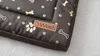 Close-up of a dog bed with a bone and paw print pattern. Náhled obrázku produktu