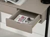 A desk drawer is open, revealing a book inside. An open magazine is on top of the desk. Anteprima dell’immagine prodotto