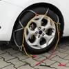 A car tire with snow chains installed, parked on a paved surface. Produktbild-Vorschau