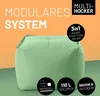 A light green modular beanbag ottoman is shown against an orange and green gradient background, with text overlays highlighting its features. Náhled obrázku produktu