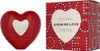 A red heart-shaped perfume bottle and its packaging are displayed side-by-side against a white background. Podgląd zdjęcia produktu