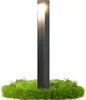 A modern, dark gray bollard light stands in a circular patch of green grass. Anteprima dell’immagine prodotto
