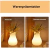 Two images of a vase lamp with flowers, side-by-side, with German text labels. Produktbild-Vorschau