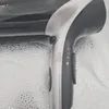 A close-up view of a black and silver hairdryer handle. Produktbild-Vorschau