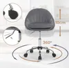 A dark gray velvet office chair with a chrome base and wheels, shown in a studio setting with graphic overlays indicating features. Produktbild-Vorschau