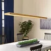 A dining room with a wooden pendant light over a table, chairs, and a plant. Náhľad obrázku produktu