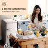 A woman is eating at a kitchen island with a retro-style refrigerator in the background. Produktbild-Vorschau
