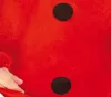 A close-up of a red fabric with black dots, possibly part of a costume. Voir les images du produit