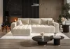 A modern living room with a sectional sofa, fireplace, and coffee tables. Produktbild-Vorschau