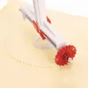 A close-up of a pastry cutter with a red serrated wheel cutting a circular pattern into yellow dough. Náhľad obrázku produktu