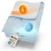 A folded blue and white blanket with glowing orange and blue spheres indicating temperature regulation. Produktbild-Vorschau
