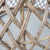 A close-up view of the woven rattan material of a table. Produktbild-Vorschau